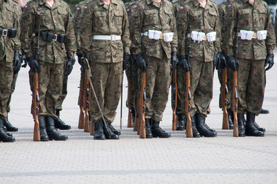 Low section of army soldiers standing on footpath