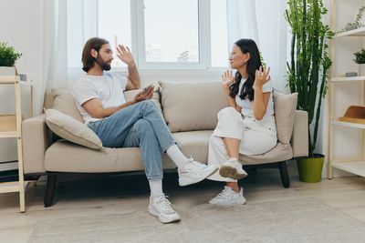 Couple sitting on sofa at home
