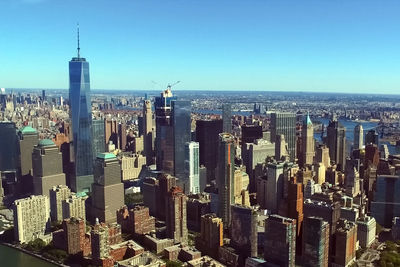 Aerial view of city buildings against clear sky