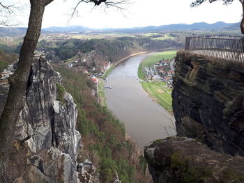 Scenic view of river amidst trees against sky