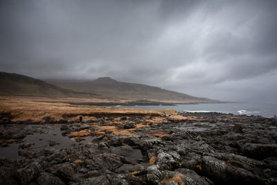 Scenic view of sea and mountains against sky