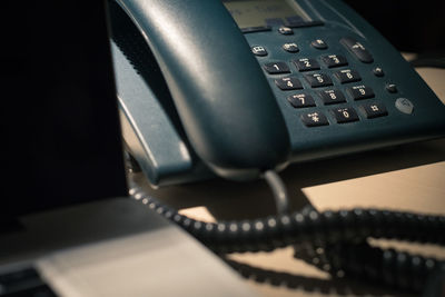 Close-up of telephone booth on table