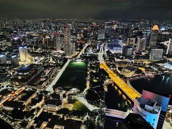 High angle view of illuminated city buildings at night