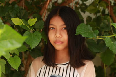 Portrait of a beautiful young woman standing outdoors