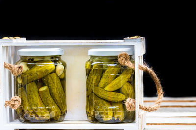 Close-up of food in jar against black background