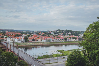 View of river and townscape against sky