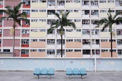Empty chairs against buildings in city