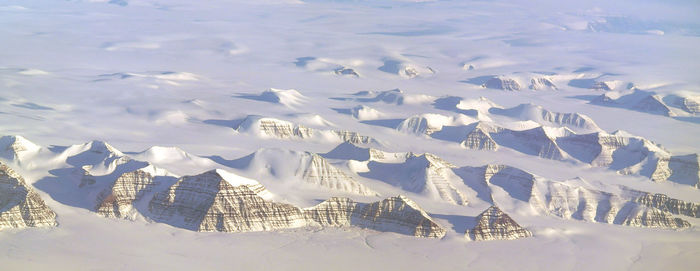 High angle view of snowcapped mountains against sky