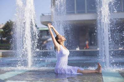 Woman enjoying at water fountain