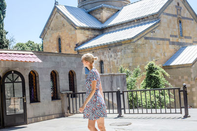 Woman standing outside building