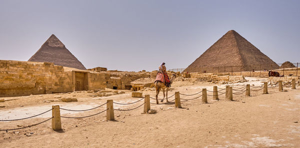 Man standing on historical building against sky