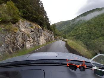 Car moving on road seen through windshield