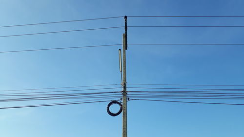 Low angle view of electricity pylon against sky