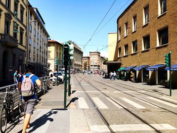 People on street in city against clear sky