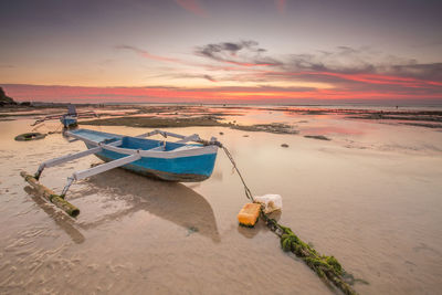 Scenic view of beach against sky during sunset