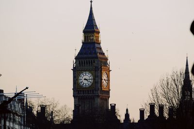 Clock tower in city against clear sky