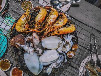 High angle view of fish on barbecue grill