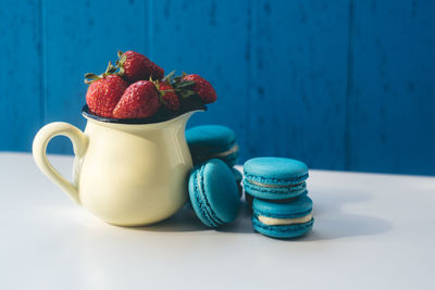 Close-up of strawberries on table against blue background