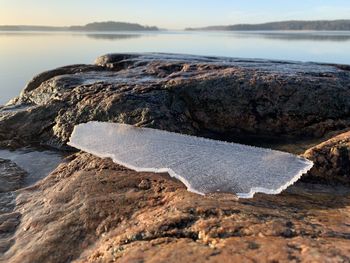 Close-up of rocks on beach against sky