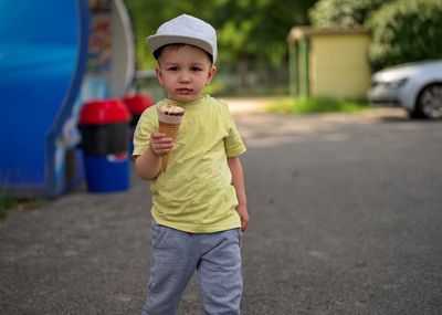 Portrait of boy standing on road