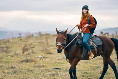 Man riding horse on field