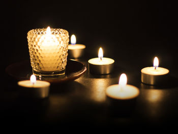 Close-up of lit candle candles in the dark