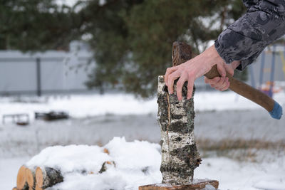 Cropped hand of man holding snow