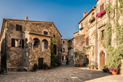 Street amidst buildings in town against sky