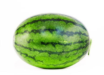 Close-up of green fruit against white background