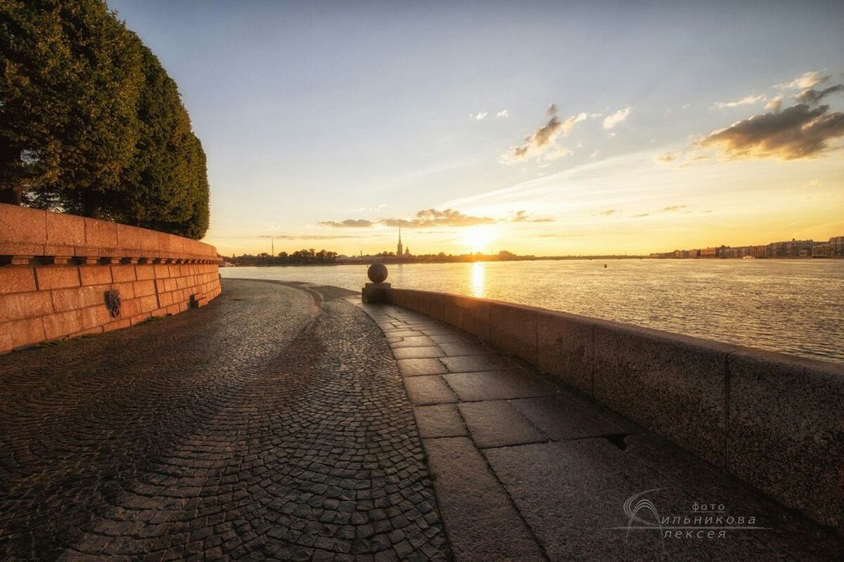 sunset, the way forward, sky, water, tranquil scene, tranquility, diminishing perspective, scenics, sea, beauty in nature, cloud - sky, sunlight, nature, vanishing point, footpath, idyllic, sun, cloud, outdoors, cobblestone