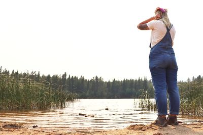 Admiring the view of the mountain lake from the beach. mud lake, near nederland, co.