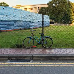 Bicycle on grass against sky