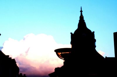 Low angle view of silhouette built structure against sky at dusk