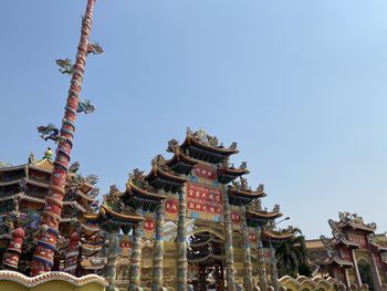 Low angle view of statues on building against sky