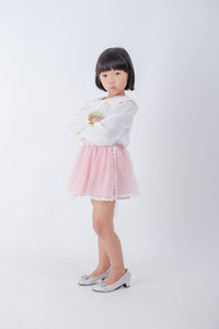 Young woman standing against white background