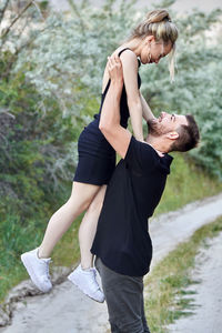 Side view of young couple embracing outdoors