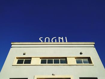 Low angle view of building against clear blue sky