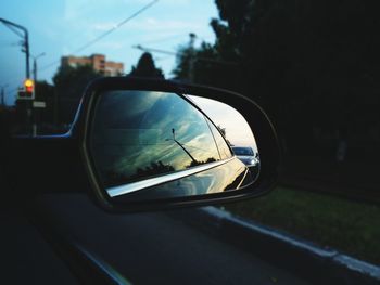 Reflection of car on side-view mirror