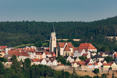 Buildings in city against clear sky