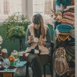 Artist painting fabric in store