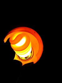 Close-up of illuminated lamp in darkroom