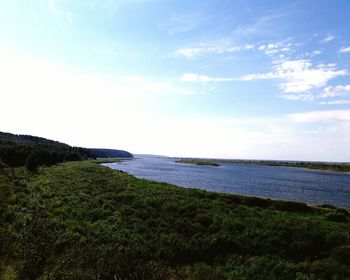 Scenic view of calm sea against cloudy sky