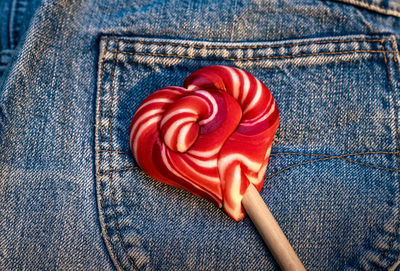 Heart shape candy on jeans