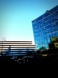 Low angle view of modern building against blue sky