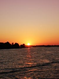 Scenic view of sea against romantic sky at sunset