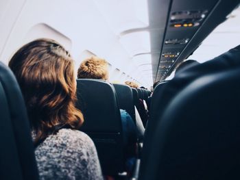 Rear view of people sitting in airplane