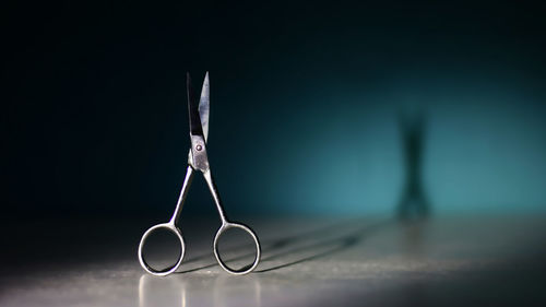 Close-up of eyeglasses on table against black background