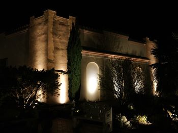 Low angle view of illuminated historic building against sky at night