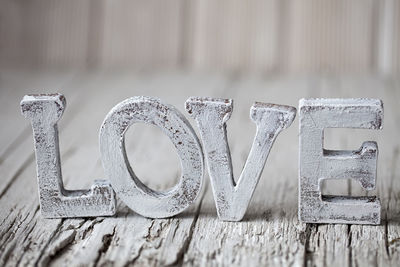 Close-up of wooden love text on table