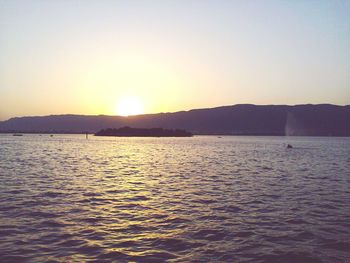 Scenic view of sea against clear sky during sunset